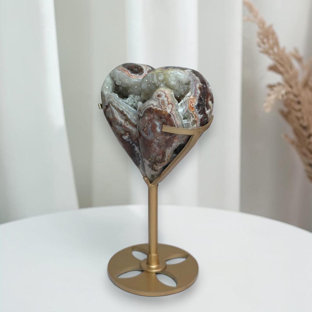 Side view showing the thick rounded agate heart on its stand