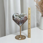 Agate heart beside a ruler showing its height with the stand