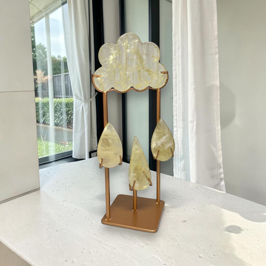 Gold-toned crystal cloud sculpture with three teardrop charms on a square base