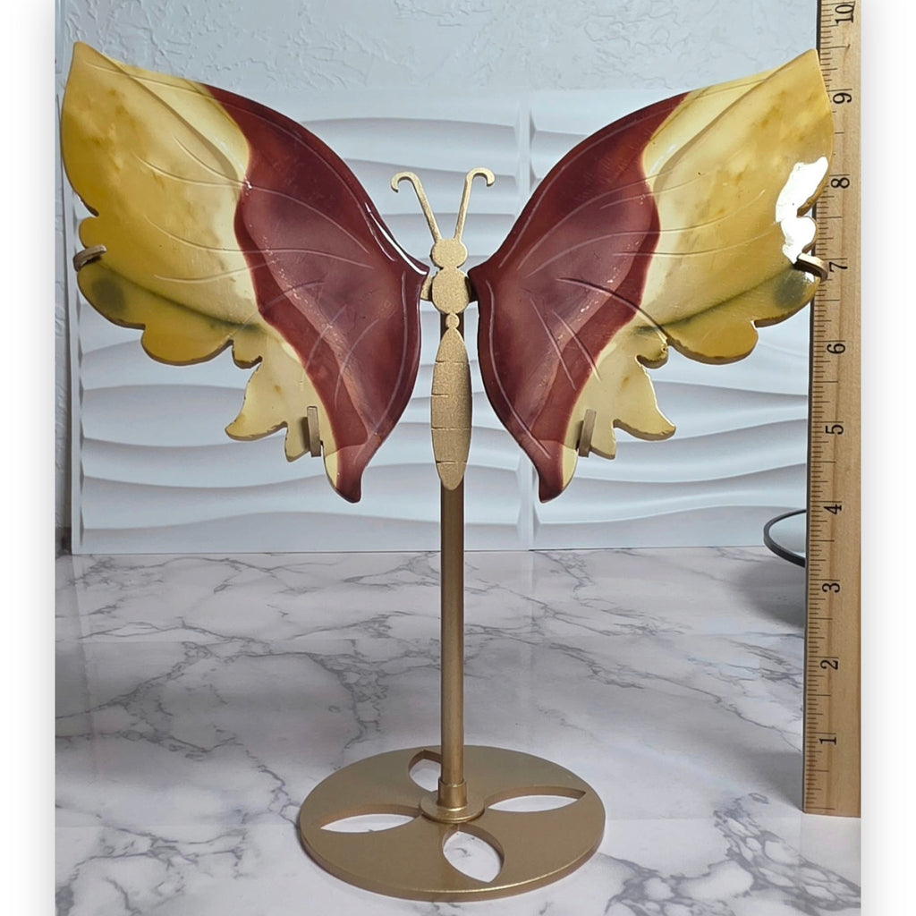 Mookaite Jasper butterfly with stand shown beside a ruler
