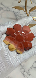 Closeup of reddish Mookaite Jasper rose carving