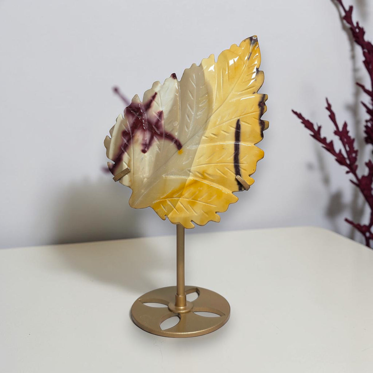 Yellow and cream Mookaite Jasper carved leaf on gold tone stand