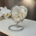 Heart-shaped stone on a metal stand with a blurred background