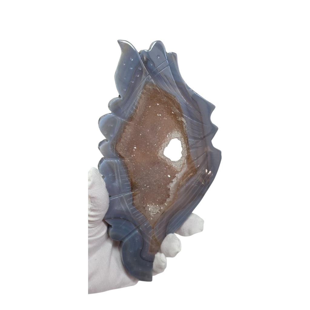 Blue agate butterfly wing crystal sculpture, close view held in hand