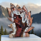 Banded Agate Nine Tails Fox Kitsune carving angle view with mountain background