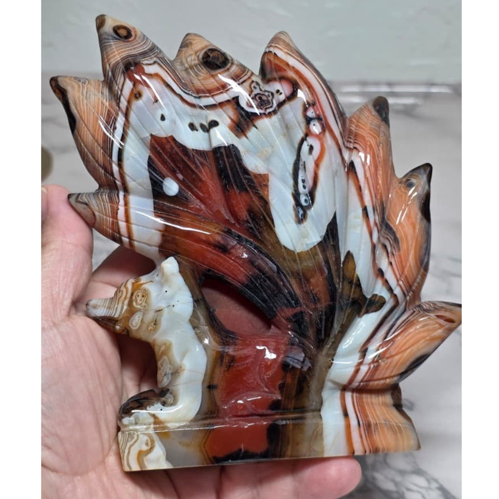 Banded Agate Nine Tails Fox held in hand showing size