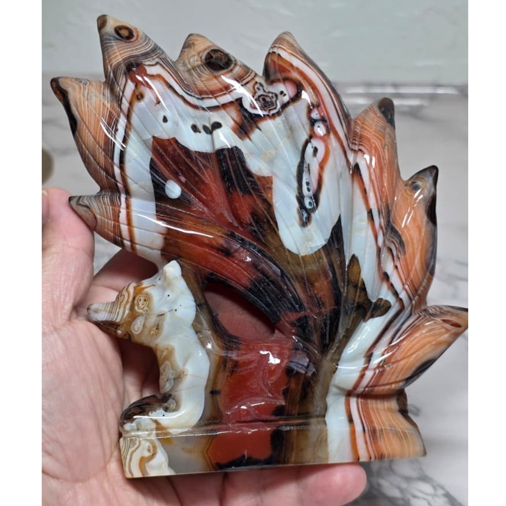 Banded Agate Nine Tails Fox held in hand showing size
