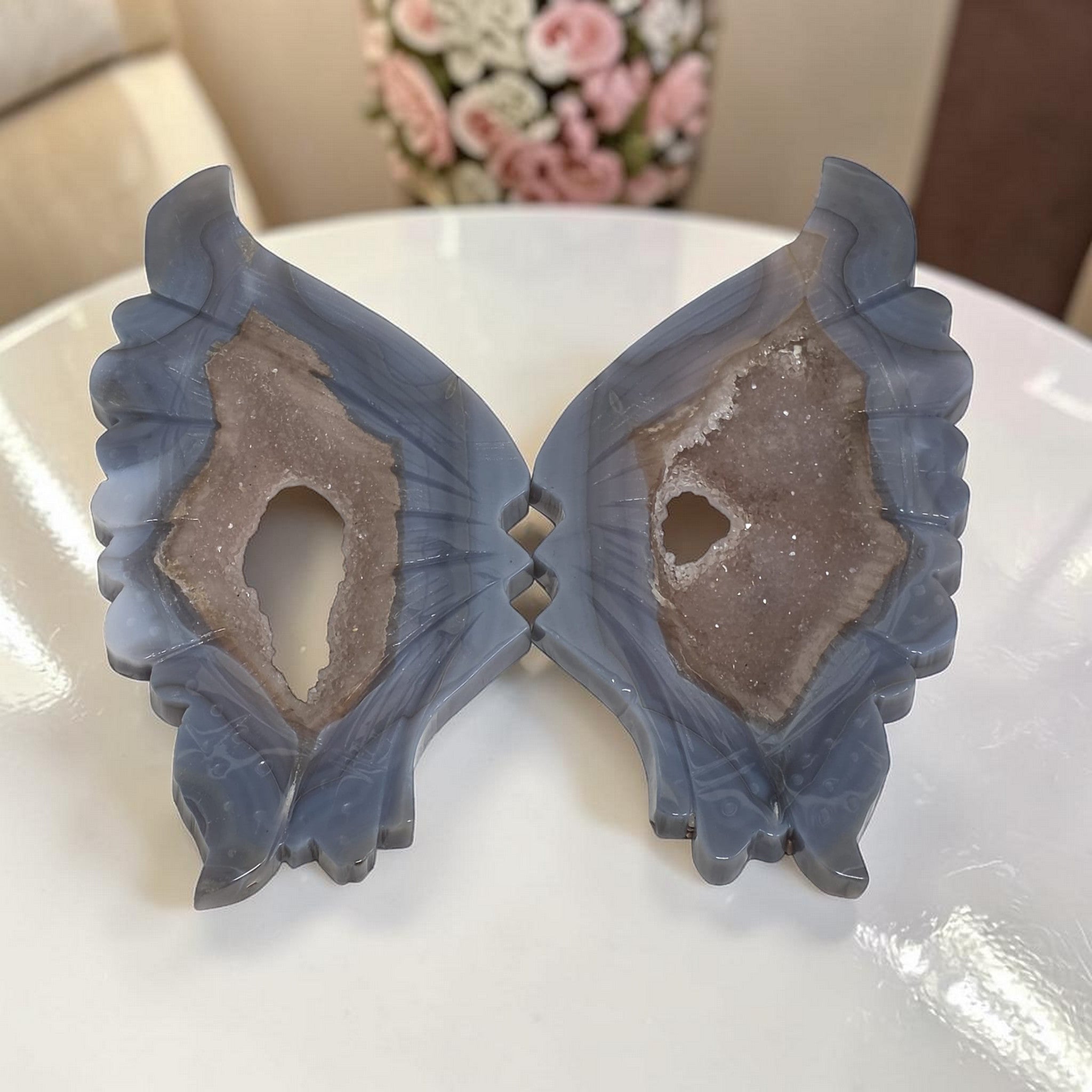 Blue agate butterfly wings crystal sculpture, resting on tabletop