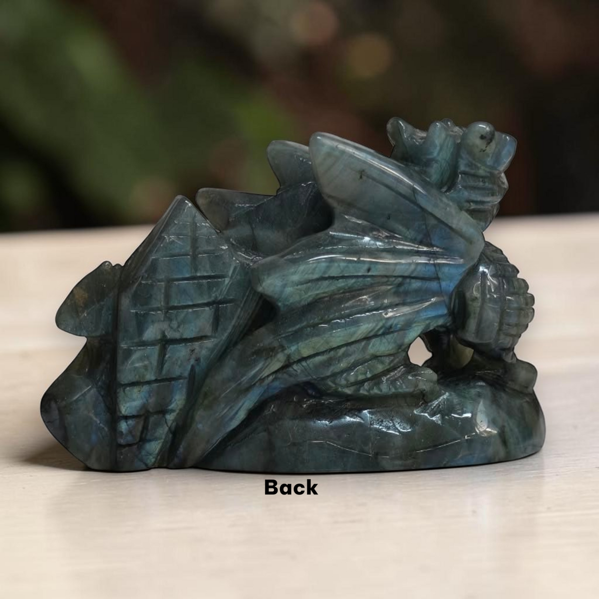 Labradorite dragon showing iridescent blue and green detail