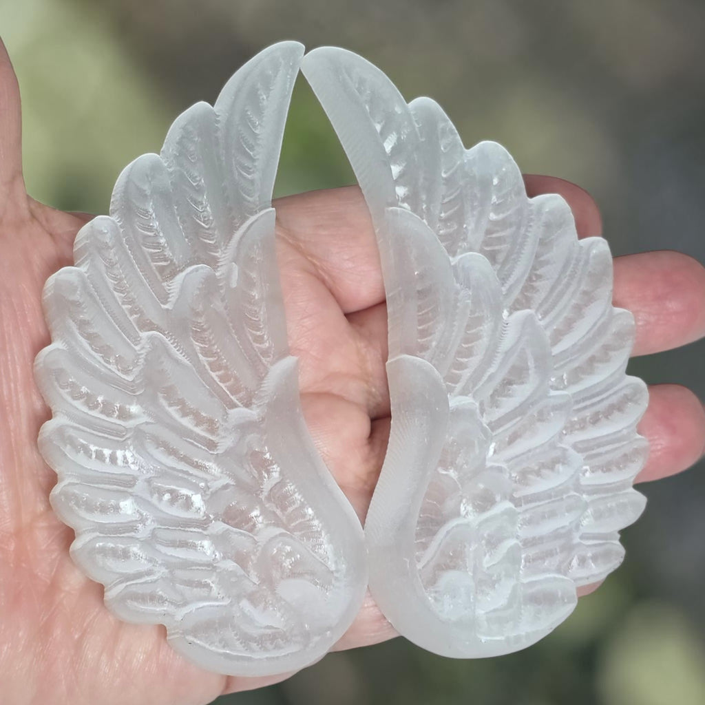Selenite angel wings with black angel silhouette on decorative stand