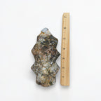 Ocean agate flame tower beside a measuring ruler, multicolor blue-gray and tan