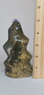 Polished ocean jasper flame-shaped stone in dark green with gold speckles; 5 in