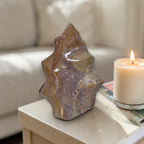 Flame-shaped ocean jasper stone in brown and purple with a green mineral patch