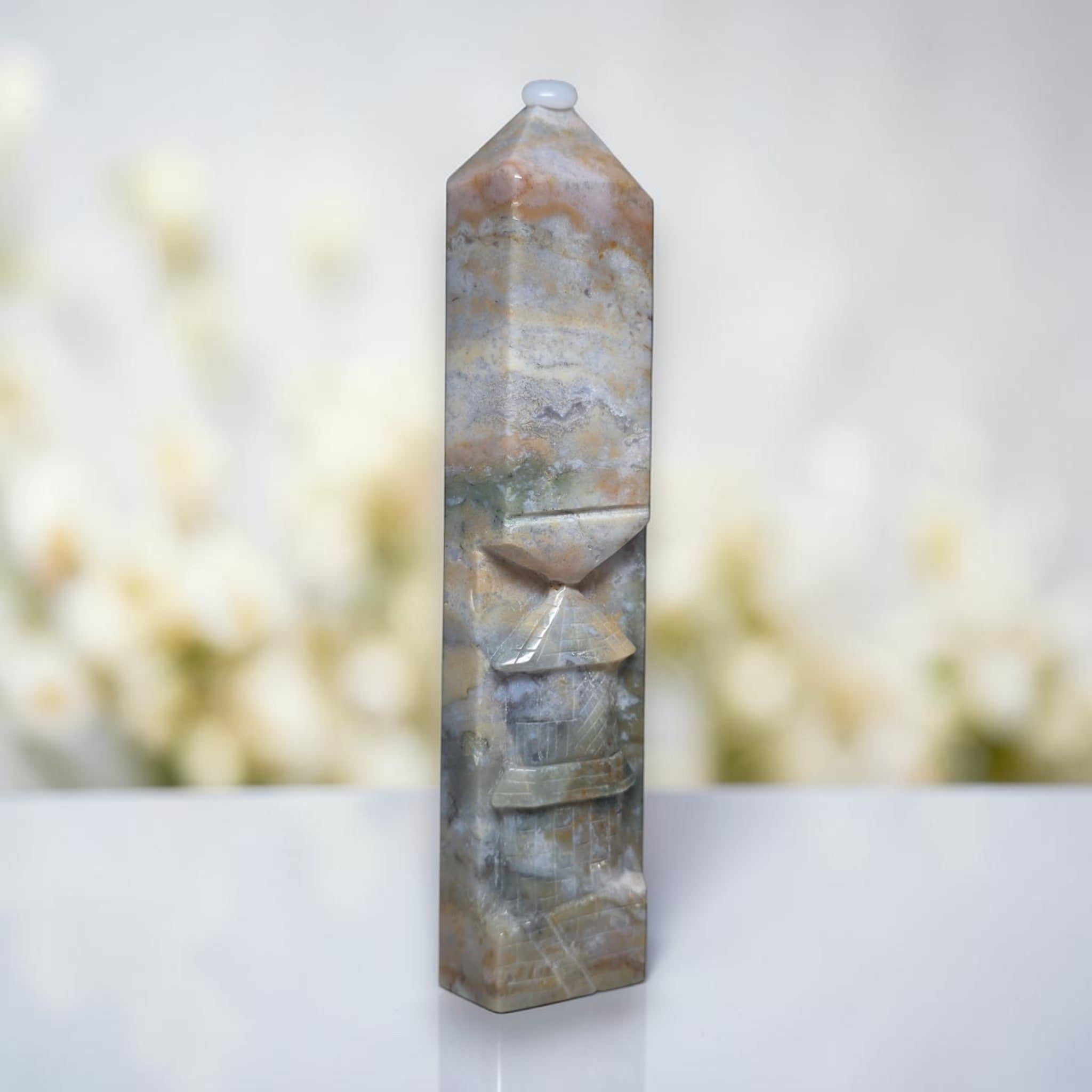 Ocean jasper tower with rounded top, swirled blue-gray and tan pattern with carved lines