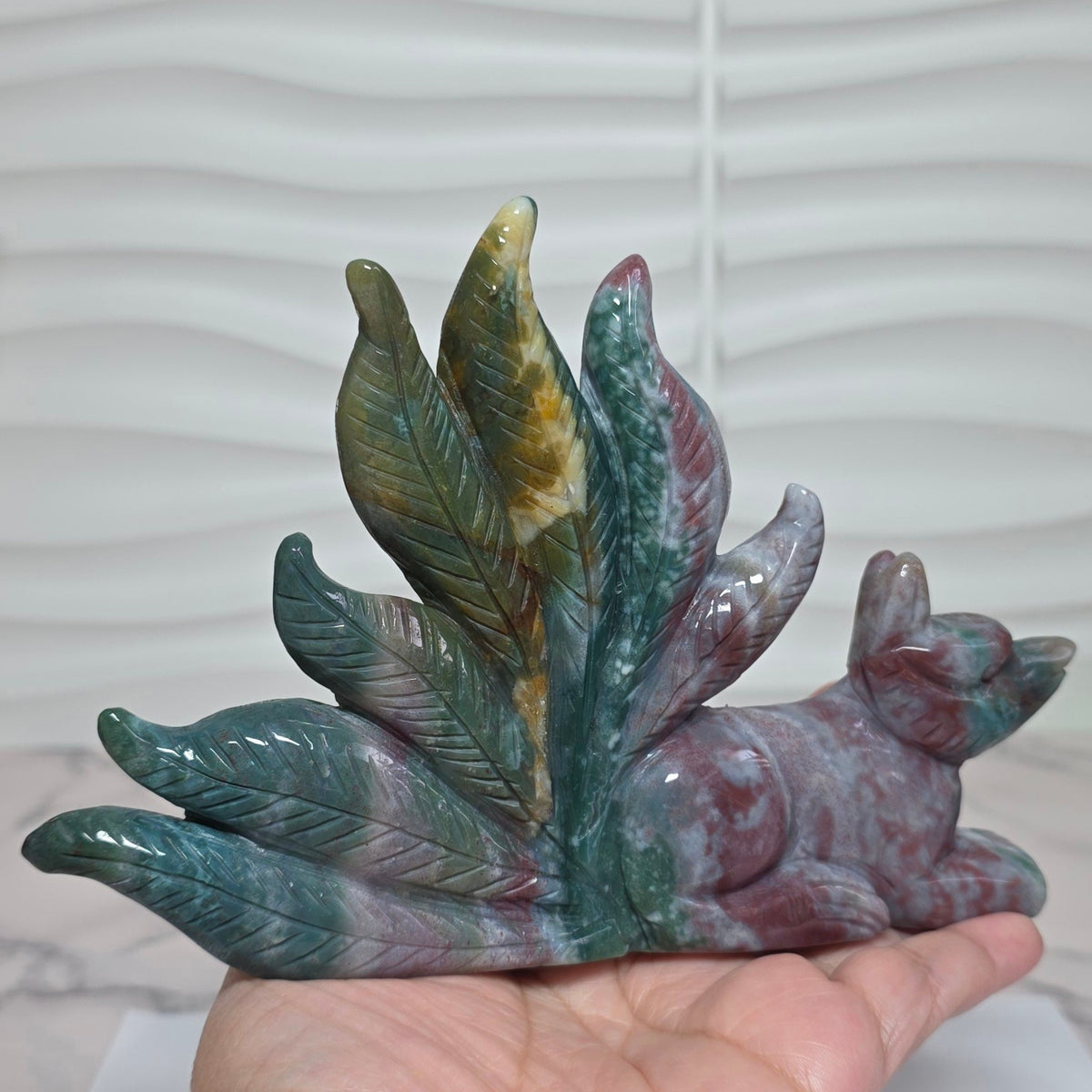 Polished ocean jasper nine tailed fox carving front view