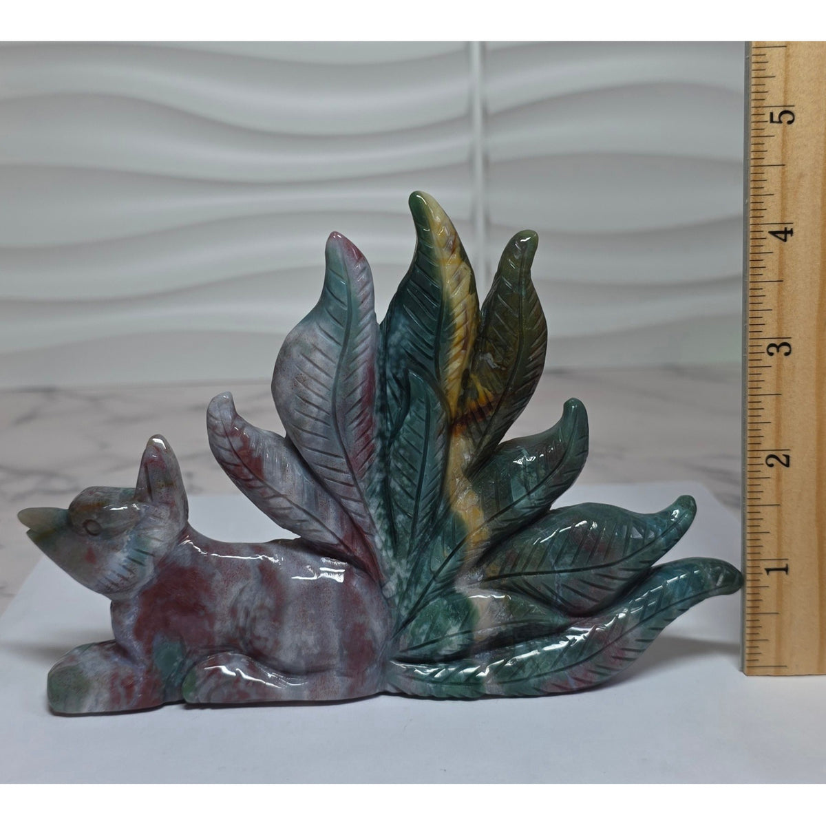 Nine tailed fox ocean jasper carving alongside ruler showing length