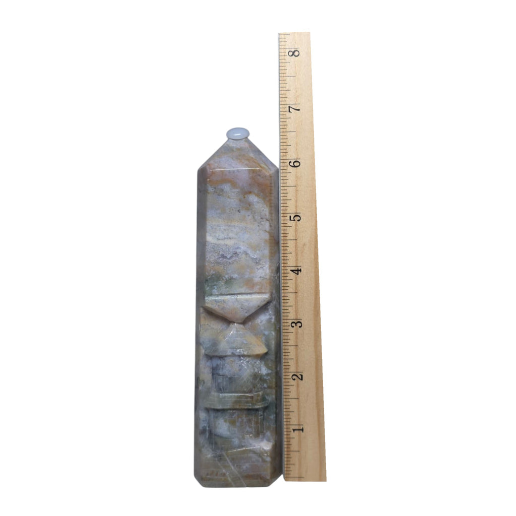 Ocean jasper carving tower beside ruler, faceted bands in blue-gray and tan