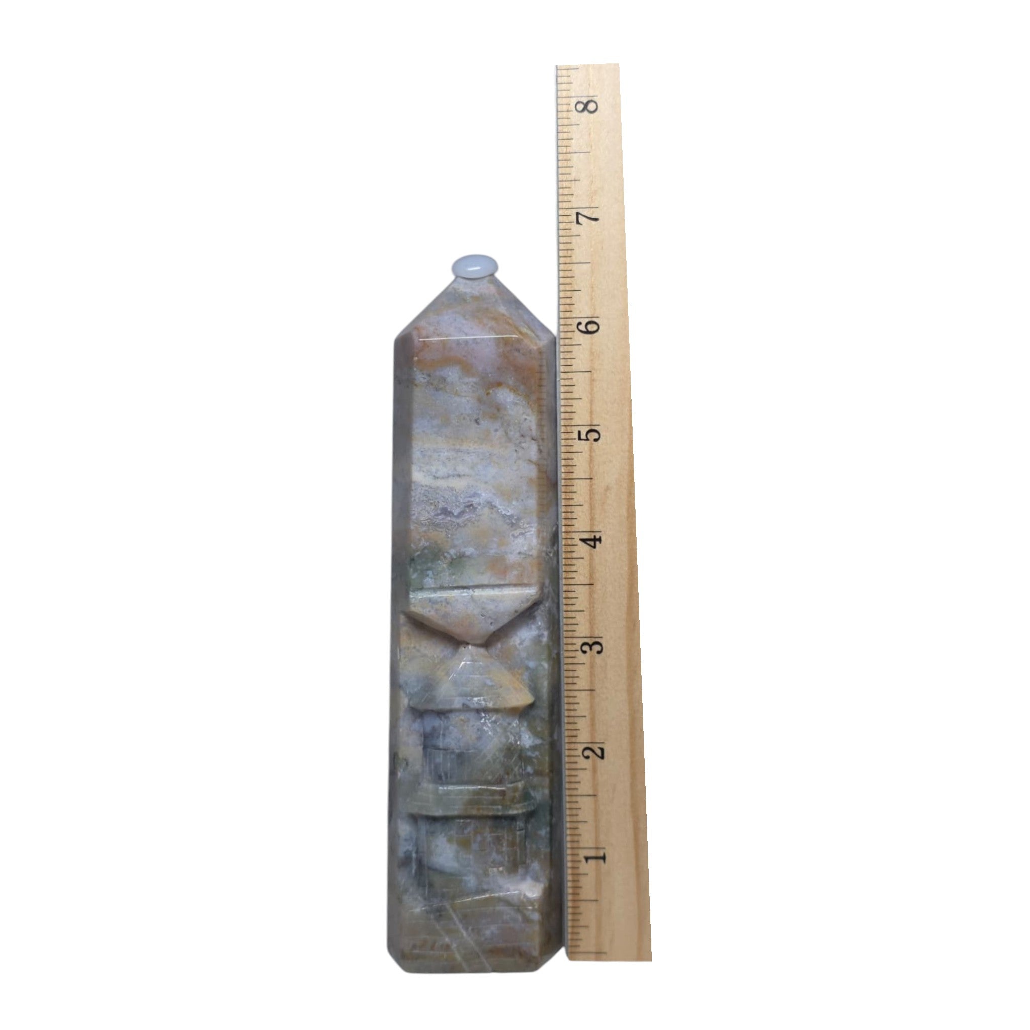 Ocean jasper carving tower beside ruler, faceted bands in blue-gray and tan