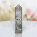Ocean jasper tower with rounded top knob and carved bands, blue-gray stone