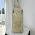 Pale yellow citrine tower on white surface