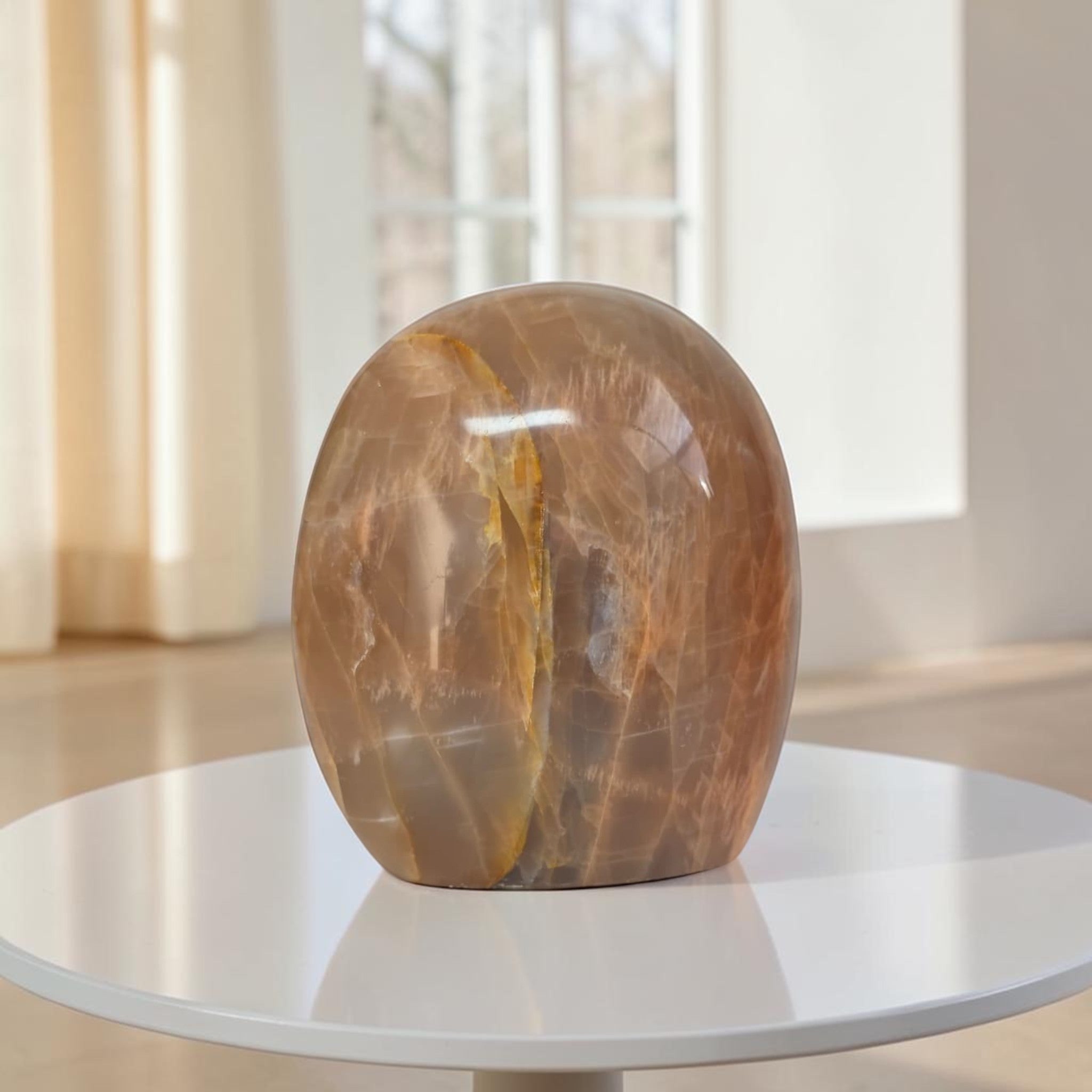 Polished peach-brown freeform crystal with curved oval top, glossy finish