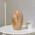 Polished peach moonstone freeform crystal, smooth oval stone.