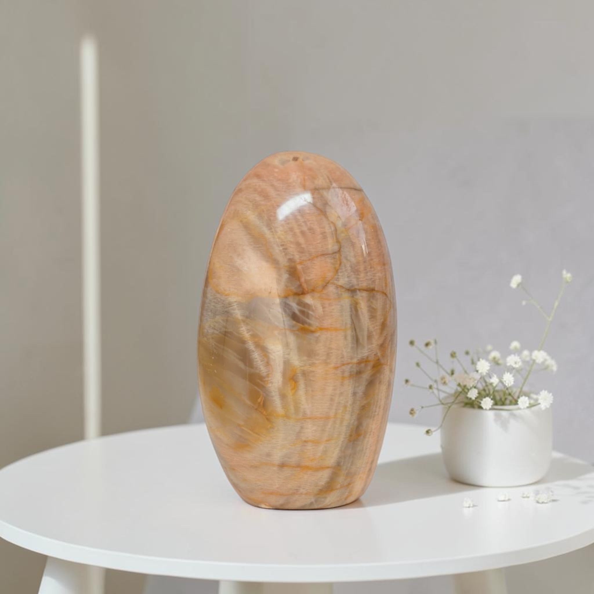 Polished peach moonstone freeform crystal, smooth oval stone.