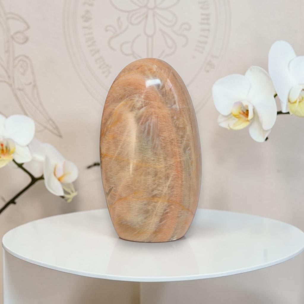 Polished peach moonstone freeform crystal, smooth rounded oval stone.