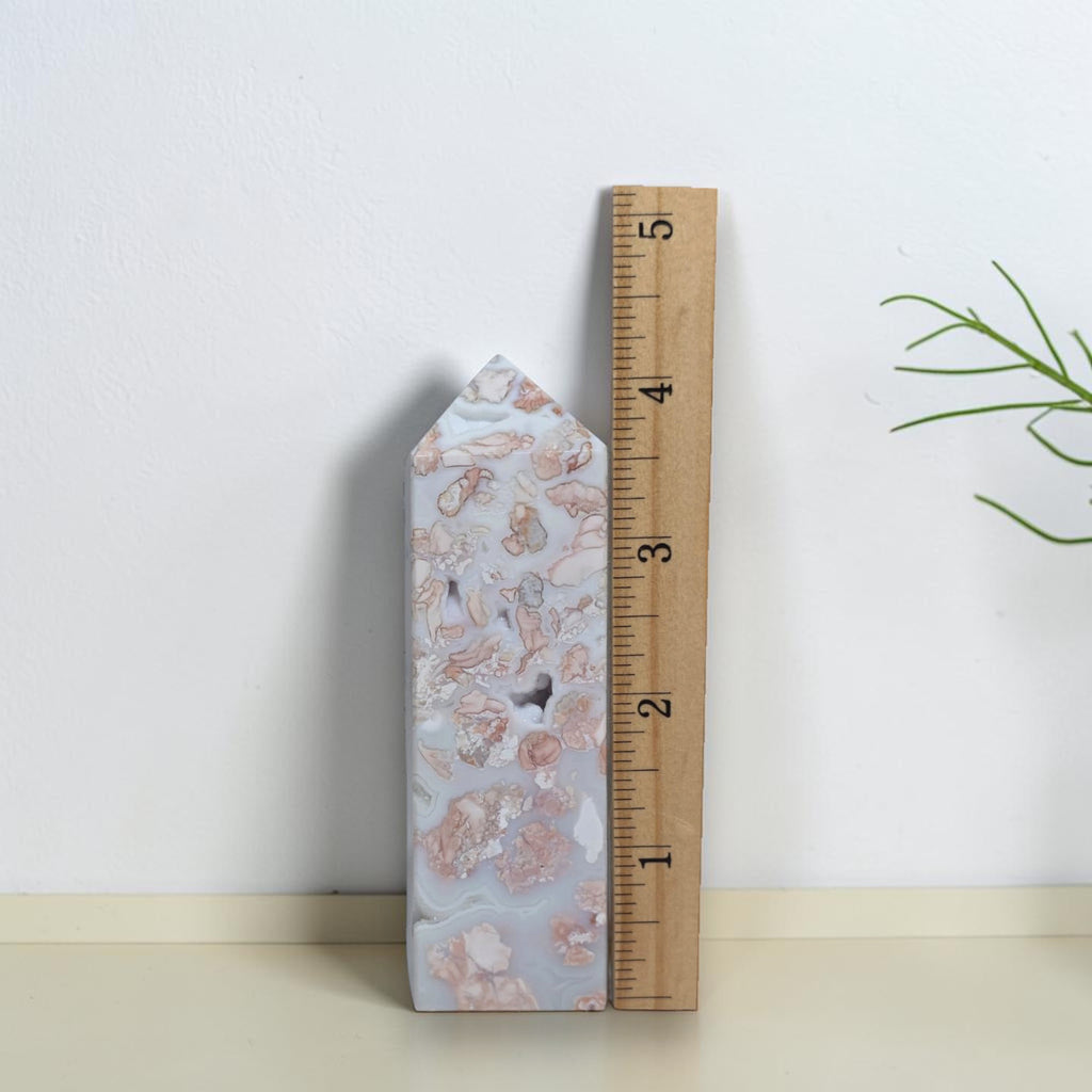 Pink Flower Agate Tower beside a ruler for size reference
