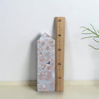 Pink Flower Agate Tower beside a ruler for size reference