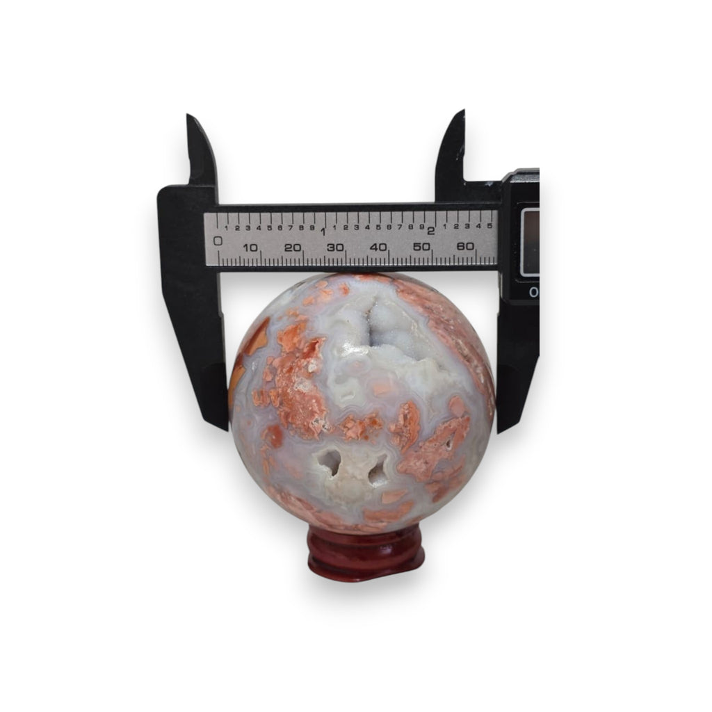 65mm agate sphere with calipers, blue-gray and orange-brown banding