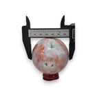 65mm agate sphere with calipers, blue-gray and orange-brown banding