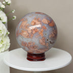 Agate sphere on stand, light blue-gray with orange and beige swirls