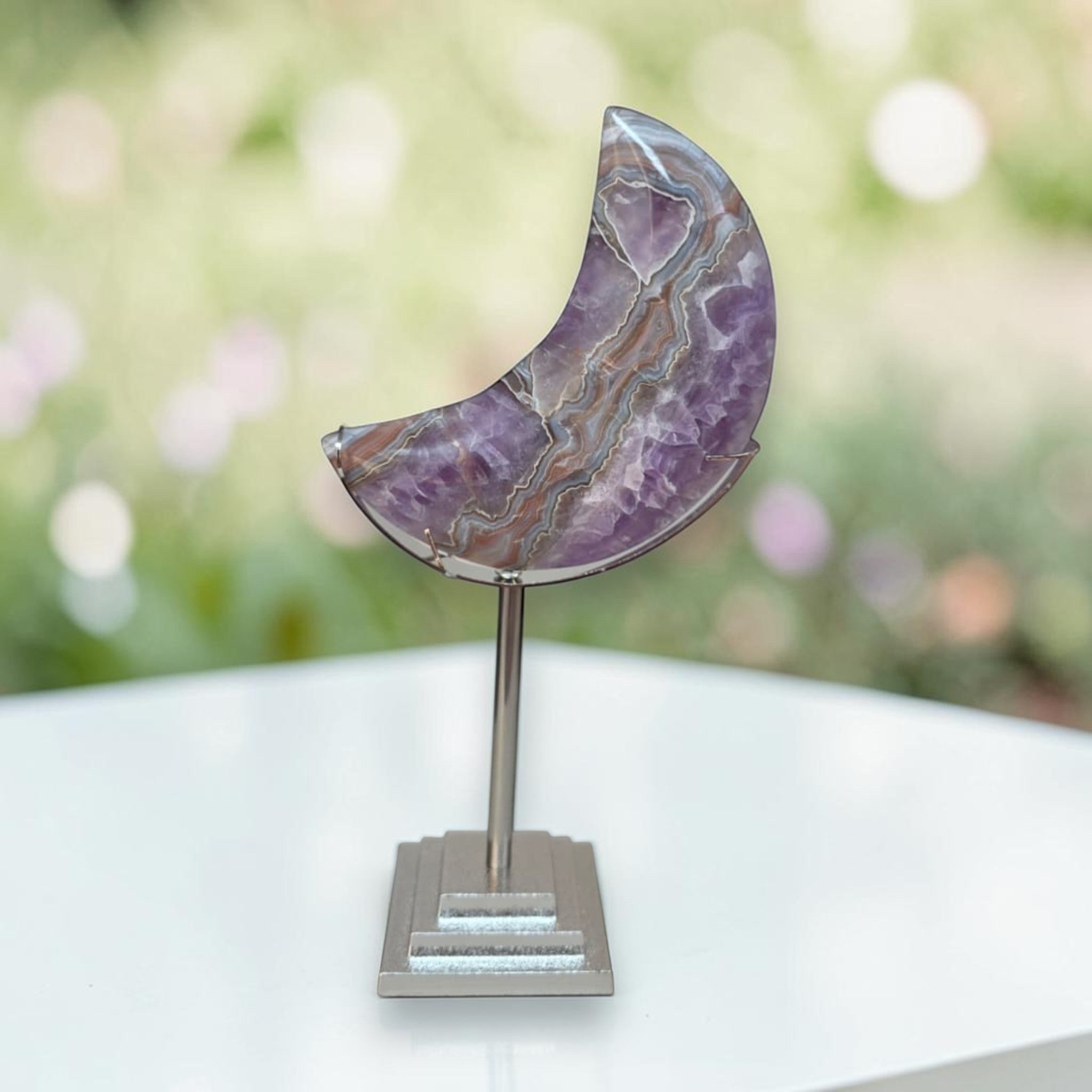 Purple banded agate crescent moon on silver metal stand