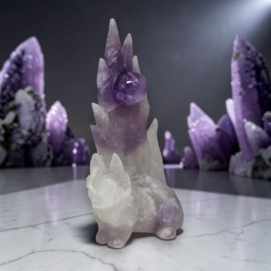 Purple amethyst nine-tailed fox carving with dramatic lighting on marble