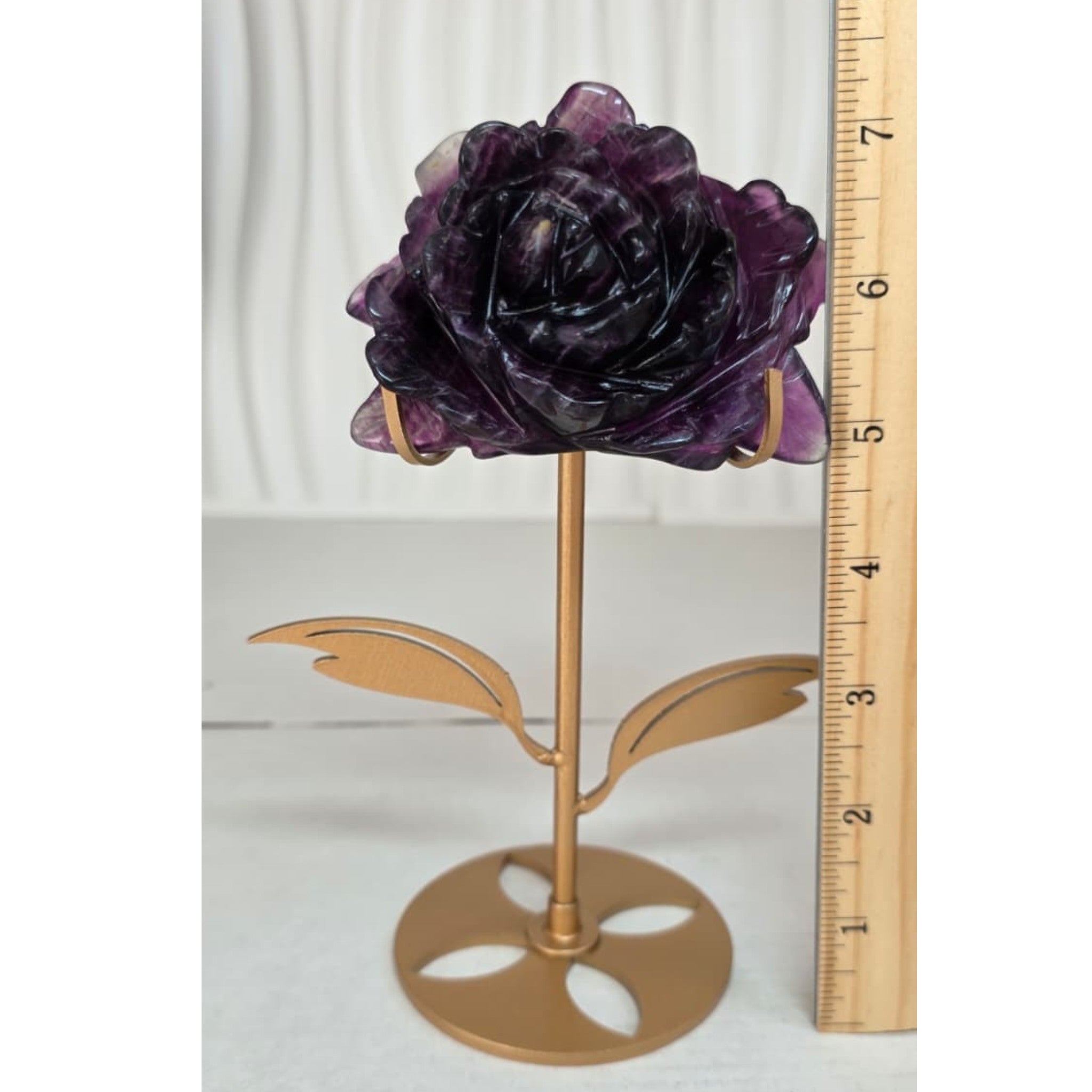 Purple fluorite rose on gold stand with ruler showing approximately 7 inches tall