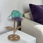 Rainbow fluorite rose on gold stand in living room shelf decor