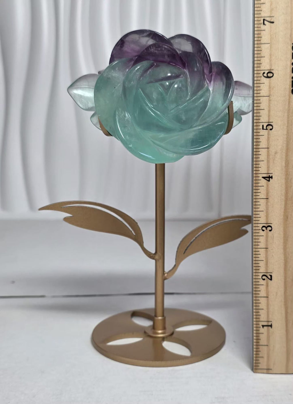 Rainbow fluorite rose carving with ruler showing approximately 7 inches tall with stand