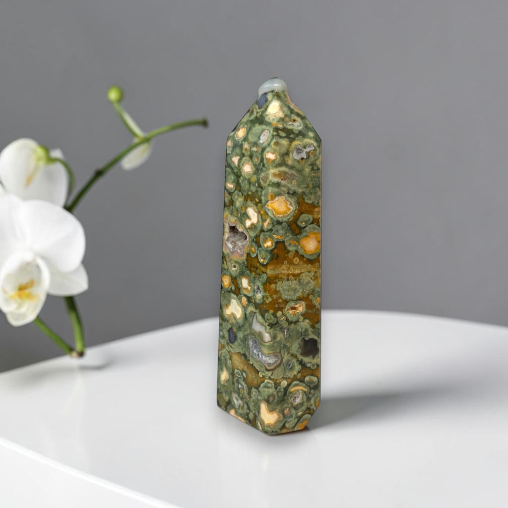 Rainforest jasper druzy tower, faceted green stone with tan patches and dark pocket inclusions
