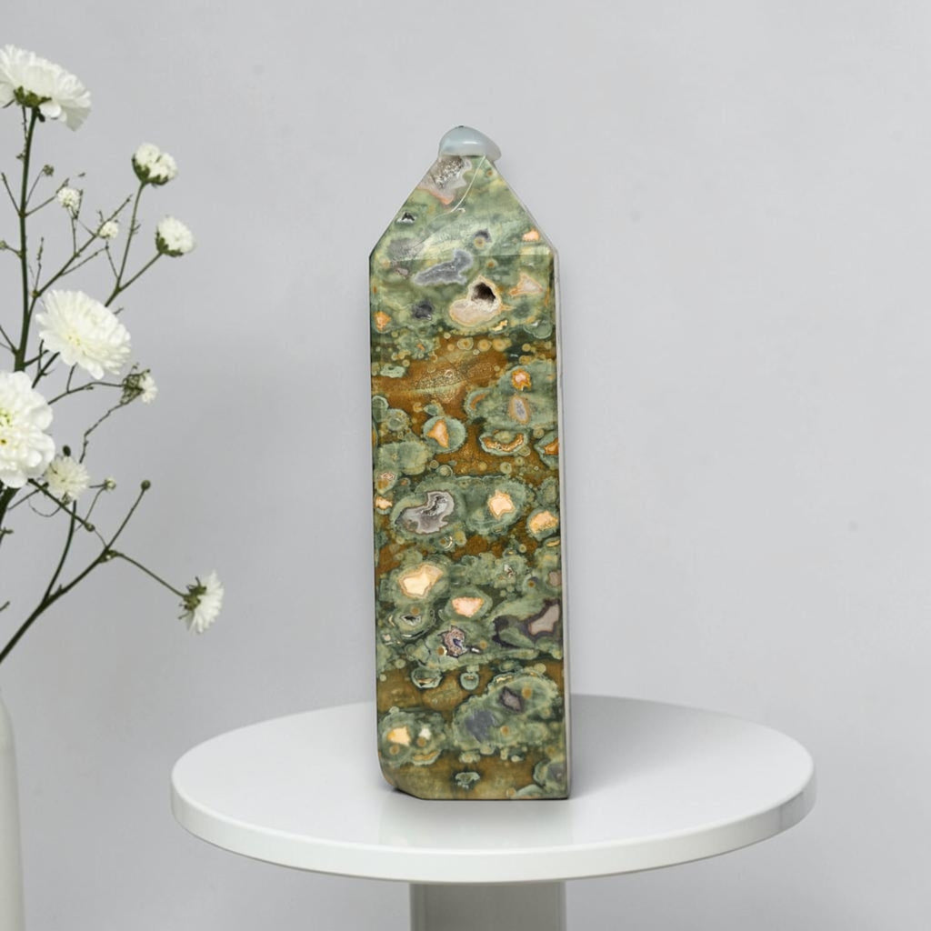 Rainforest jasper druzy tower, green-and-brown stone with tan druzy-like spots and gray pits