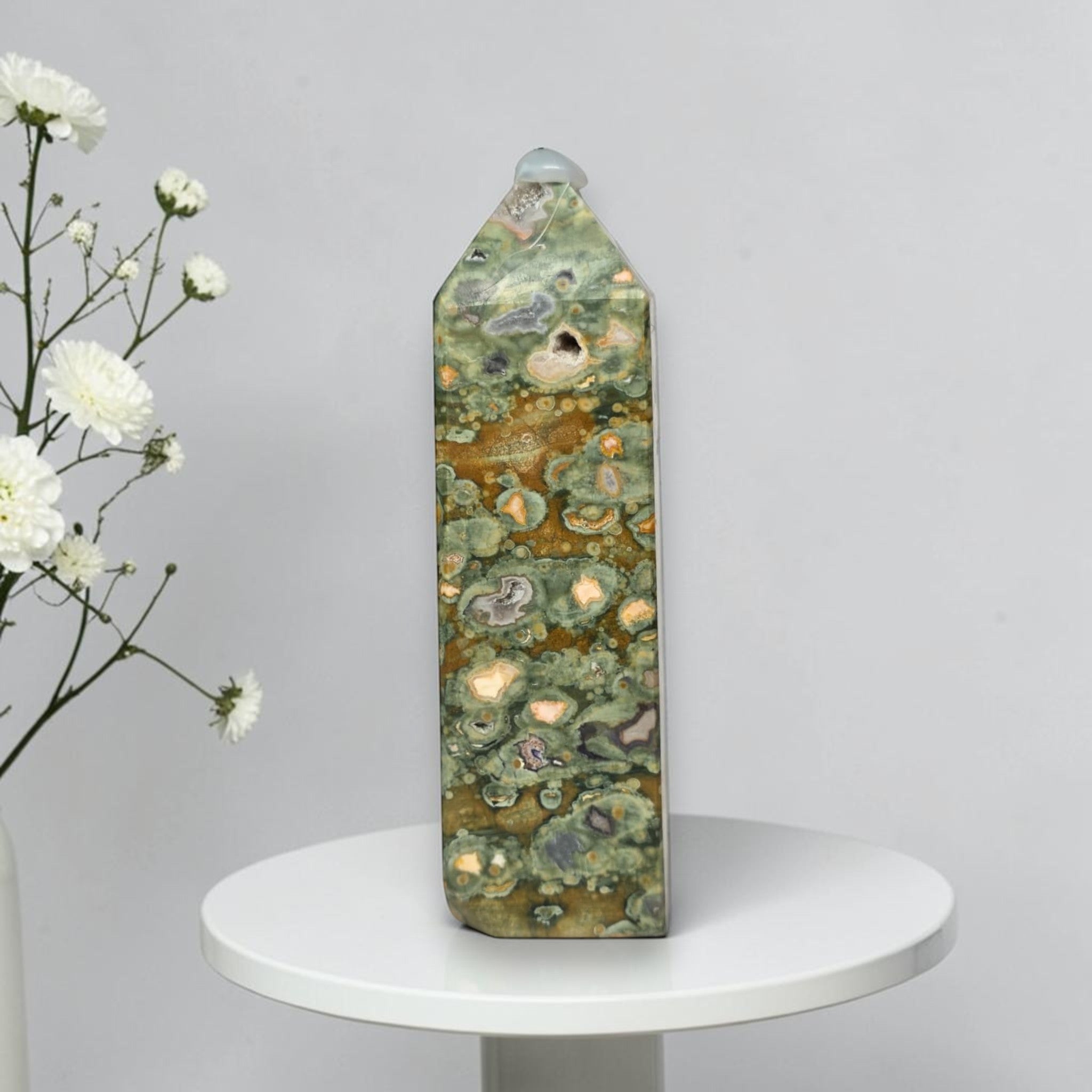 Rainforest jasper druzy tower, green-and-brown stone with tan druzy-like spots and gray pits