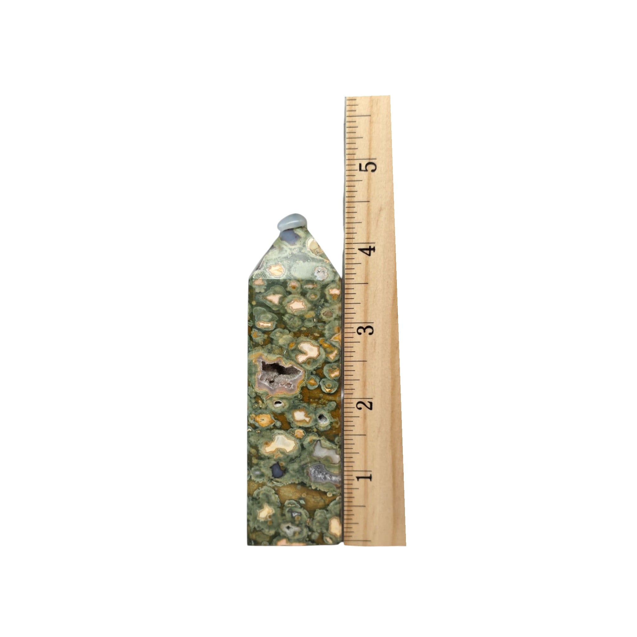 Rainforest jasper druzy tower beside measuring stick, green mosaic stone with tan flecks