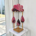 Rhodonite rain cloud crystal sculpture with pink cloud and four hanging teardrops on gold stand