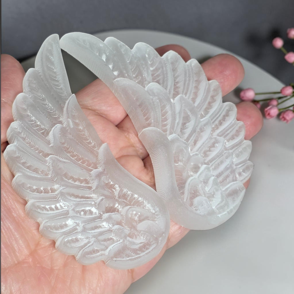Close view of carved selenite angel wing feather detail