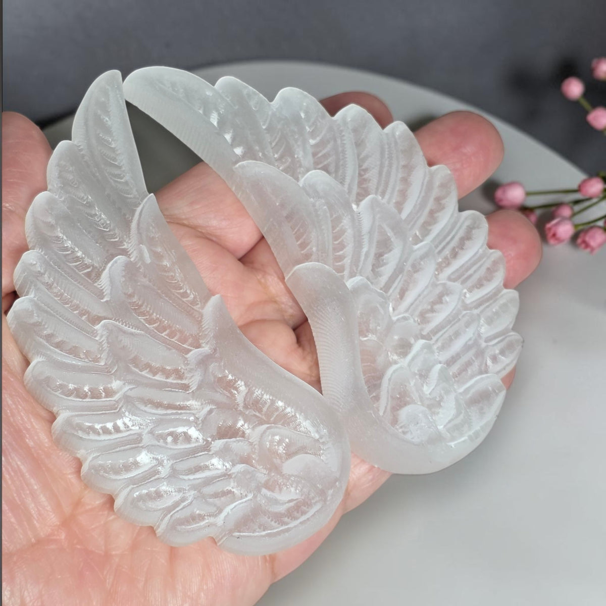 Close view of carved selenite angel wing feather detail