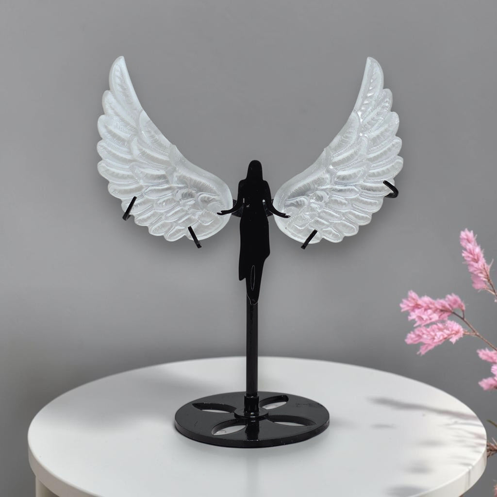 Translucent carved selenite angel wings held in hand