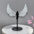 Translucent carved selenite angel wings held in hand