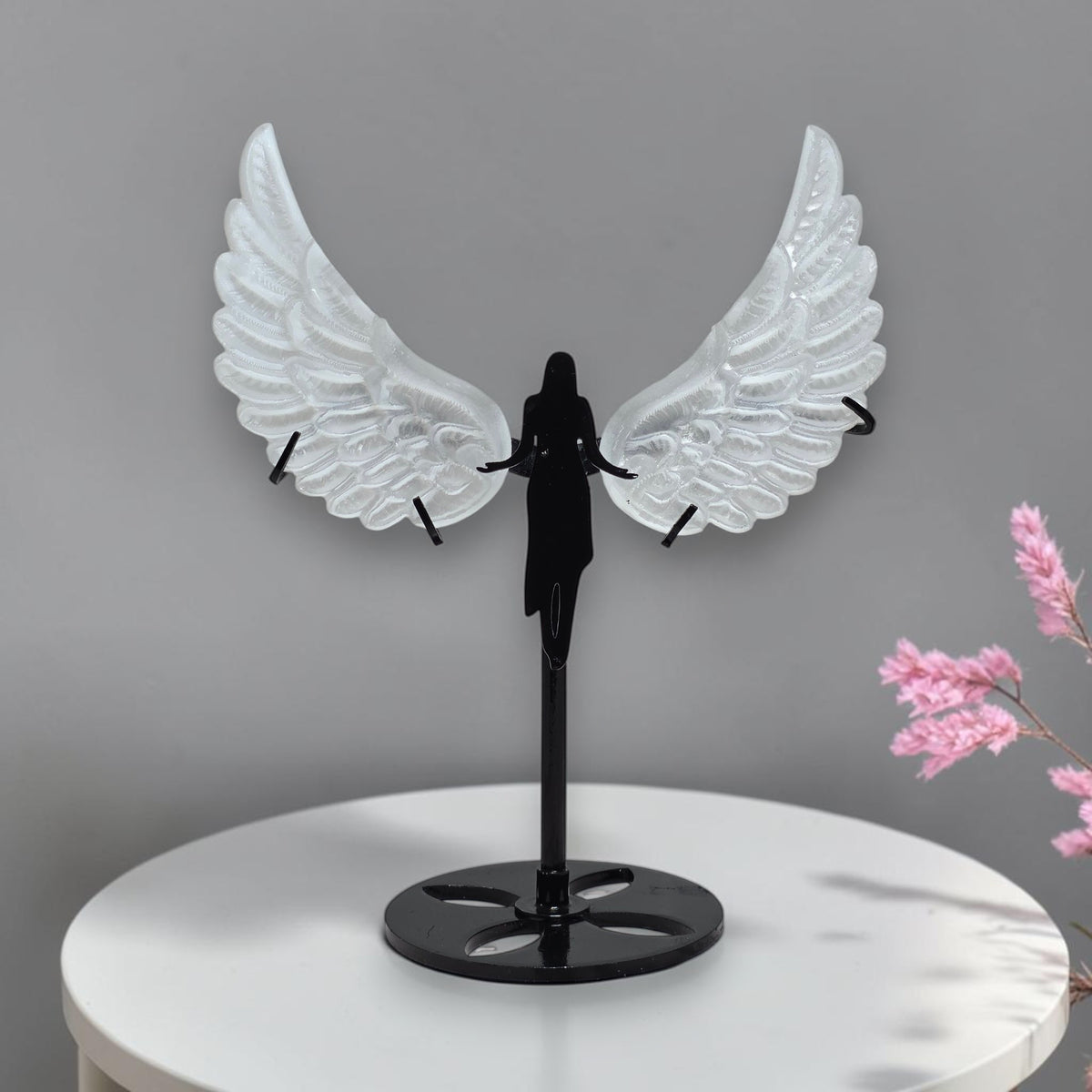 Translucent carved selenite angel wings held in hand