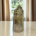 Smoky quartz crystal tower showing internal rainbow flashes