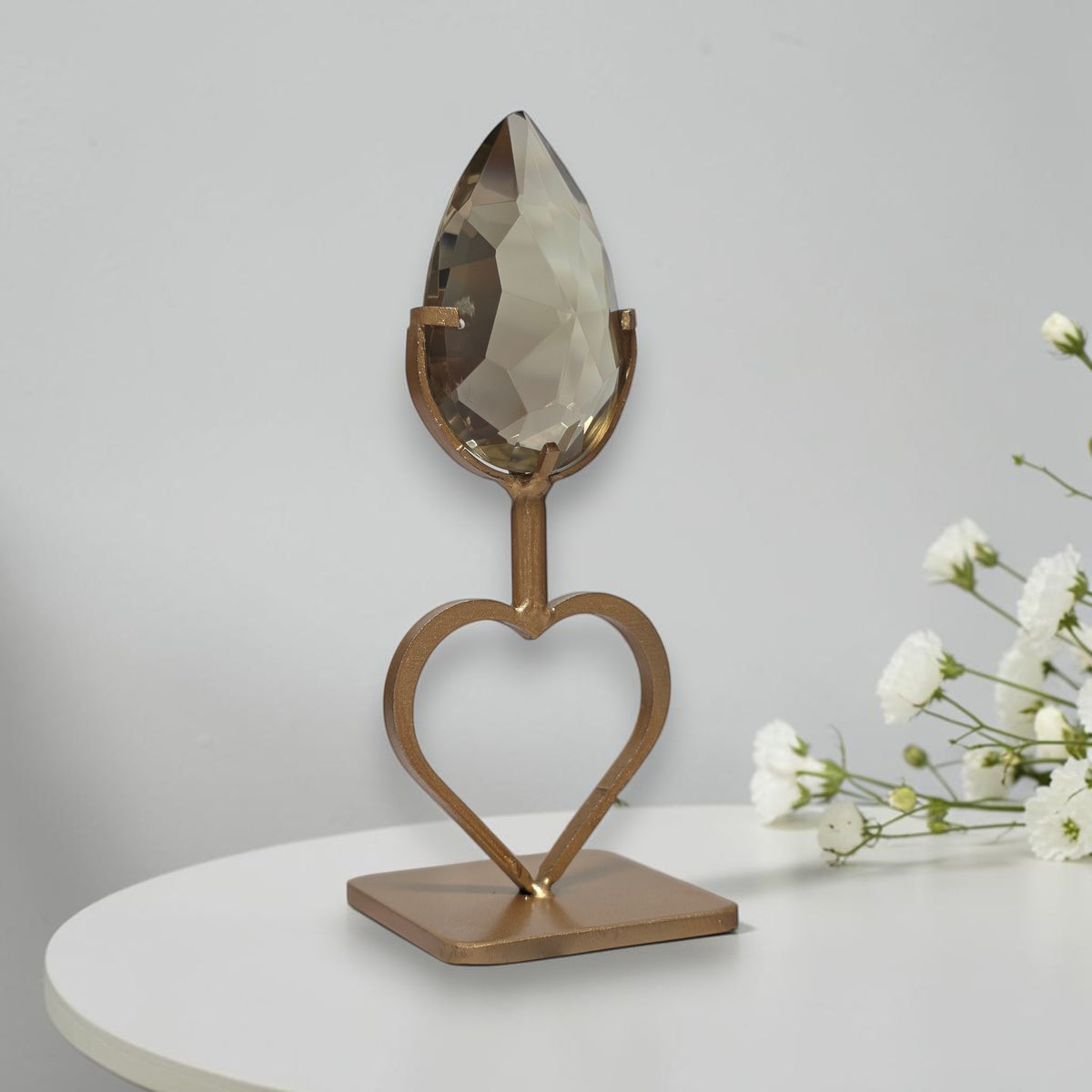 Smoky quartz heart stand displayed with white flowers